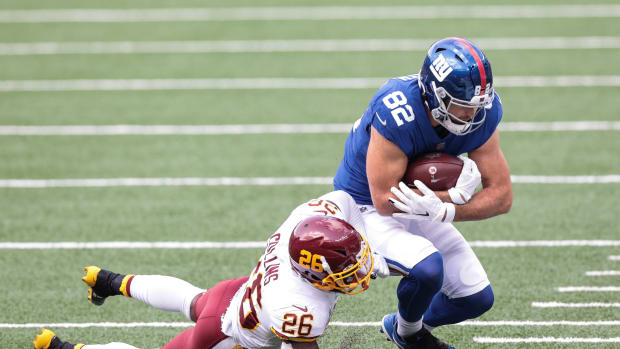 Oct 18, 2020; East Rutherford, New Jersey, USA; New York Giants tight end Kaden Smith (82) is tackled by Washington Football Team safety Landon Collins (26) during the first half at MetLife Stadium. Mandatory Credit: Vincent Carchietta-USA TODAY Sports